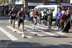 Three elite men runners run neck and neck at about 11 and a half miles in Brooklyn. At the right is Albert Korir of Kenya who finished first.