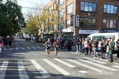 Two top male runners speed through Brooklyn at approximately 11.5 miles. At the left is Mohamed El Aaraby of Morocco who finished second along with Eyob Faniel of Italy who finished third.
