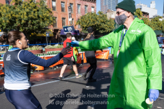 A volunteer hands Gatorade to a runner of the 50th TSC New York City Marathon in New York, New York, on Nov. 7, 2021. (Photo by Gabriele Holtermann)