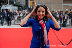 NYC Veterans Day Parade offers up a variety of people, both marchers and spectators 11/11/21.  ABC news anchor prepares to go on air.