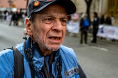 NYC Veterans Day Parade offers up a variety of people, both marchers and spectators 11/11/21. NYPPA member and veteran Al Freni watches the festivities between taking photos.