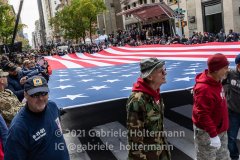 Parade marchers carry a large US flag during the 102nd Annual New York City Veterans Day Parade in New York, New York, on Nov.11, 2021. (Photo by Gabriele Holtermann/Sipa USA)