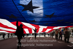 Parade marchers carry a large US flag during the 102nd Annual New York City Veterans Day Parade in New York, New York, on Nov.11, 2021. (Photo by Gabriele Holtermann/Sipa USA)
