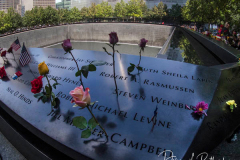 NEW YORK, NEW YORK - SEPTEMBER 11: Flowers are placed into the inscribed names of the victims of the 9/11 attacks and in the 1993 World Trade Center bombing during the annual commemoration ceremony at the National 9/11 Memorial and Museum on September 11, 2021 in New York City. The nation is marking the 20th anniversary of the terror attacks of September 11, 2001, when the terrorist group al-Qaeda flew hijacked airplanes into the World Trade Center, Shanksville, PA and the Pentagon, killing nearly 3,000 people