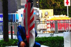 Germano Rvieira sits with the flag of honor near the north reflecting pool at the 9/11 Memorial on the 20th anniversary of the September 11 attacks in Manhattan, New York on September 11, 2021.