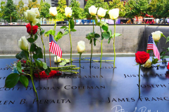NEW YORK, NEW YORK - SEPTEMBER 11: Flowers are placed into the inscribed names of the victims of the 9/11 attacks and in the 1993 World Trade Center bombing during the annual commemoration ceremony at the National 9/11 Memorial and Museum on September 11, 2021 in New York City. The nation is marking the 20th anniversary of the terror attacks of September 11, 2001, when the terrorist group al-Qaeda flew hijacked airplanes into the World Trade Center, Shanksville, PA and the Pentagon, killing nearly 3,000 people