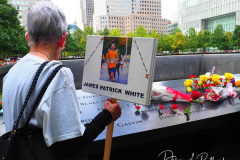 NEW YORK, NEW YORK - SEPTEMBER 11: Flags and flowers adorn the names of the victims of the attacks of Sept. 11, 2001, during a ceremony at the 9/11 Memorial and Museum on September 11, 2021 in New York City. The nation is marking the 20th anniversary of the terror attacks of September 11, 2001, when the terrorist group al-Qaeda flew hijacked airplanes into the World Trade Center, Shanksville, PA and the Pentagon, killing nearly 3,000 people.