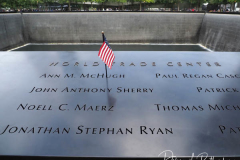 NEW YORK, NEW YORK - SEPTEMBER 11: Flags and flowers adorn the names of the victims of the attacks of Sept. 11, 2001, during a ceremony at the 9/11 Memorial and Museum on September 11, 2021 in New York City. The nation is marking the 20th anniversary of the terror attacks of September 11, 2001, when the terrorist group al-Qaeda flew hijacked airplanes into the World Trade Center, Shanksville, PA and the Pentagon, killing nearly 3,000 people.