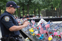 A member of the NYPD during the annual commemoration ceremony at the National 9/11 Memorial and Museum on September 11, 2021 in New York City. The nation is marking the 20th anniversary of the terror attacks of September 11, 2001, when the terrorist group al-Qaeda flew hijacked airplanes into the World Trade Center, Shanksville, PA and the Pentagon, killing nearly 3,000 people