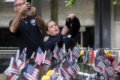 NEW YORK, NEW YORK - SEPTEMBER 11: Flags and flowers adorn the names of the victims of the attacks of Sept. 11, 2001, during a ceremony at the 9/11 Memorial and Museum on September 11, 2021 in New York City. The nation is marking the 20th anniversary of the terror attacks of September 11, 2001, when the terrorist group al-Qaeda flew hijacked airplanes into the World Trade Center, Shanksville, PA and the Pentagon, killing nearly 3,000 people.