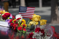 NEW YORK, NEW YORK - SEPTEMBER 11: Flowers are placed into the inscribed names of the victims of the 9/11 attacks and in the 1993 World Trade Center bombing during the annual commemoration ceremony at the National 9/11 Memorial and Museum on September 11, 2021 in New York City. The nation is marking the 20th anniversary of the terror attacks of September 11, 2001, when the terrorist group al-Qaeda flew hijacked airplanes into the World Trade Center, Shanksville, PA and the Pentagon, killing nearly 3,000 people