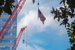 Crane held flags hung at half mast at the 9/11 Memorial South Pool at One World Trade Center in downtown Manhattan. 
An array of events were scheduled throughout NYC to honor and remember the catastrophe that shook the world in 2001. September 11, 2021 (C)Bianca Otero