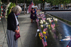 A woman lost in thought, stands at the place of  her lost family member at the South Pool of the 9/11 memorial. 
Hundreds of people came to the memorial to pay tribute to their family members and loved ones marking the 20th anniversary of the tragedy that struck NYC and shocked the world on 9/11/01. (C) Bianca Otero