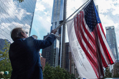 A man waves a "flag of honor" for those lost on 9/11 at the South Pool of the 9/11 memorial. 
Hundreds of people came to the memorial to pay tribute to their family members and loved ones marking the 20th anniversary of the tragedy that struck NYC and shocked the world on 9/11/01. (C) Bianca Otero