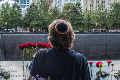A woman lost in thought, stands  at the South Pool of the 9/11 memorial. 
Hundreds of people came to the memorial to pay tribute to their family members and loved ones marking the 20th anniversary of the tragedy that struck NYC and shocked the world on 9/11/01. (C) Bianca Otero