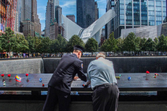 Two men make a pencil rubbing of the name of their lost family member at the North Pool of the 9/11 memorial. 
Hundreds of people came to the memorial to pay tribute to their family members and loved ones marking the 20th anniversary of the tragedy that struck NYC and shocked the world on 9/11/01. (C) Bianca Otero