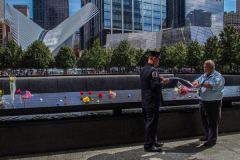Two men roll a pencil rubbing of a lost family member at the North Pool of the 9/11 memorial. 
Hundreds of people came to the memorial to pay tribute to their family members and loved ones marking the 20th anniversary of the tragedy that struck NYC and shocked the world on 9/11/01. (C) Bianca Otero