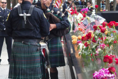 Two firemen play tribute to their colleague and friend at the North  Pool of the 9/11 memorial. 
Hundreds of people came to the memorial to pay tribute to their family members and loved ones marking the 20th anniversary of the tragedy that struck NYC and shocked the world on 9/11/01. (C) Bianca Otero