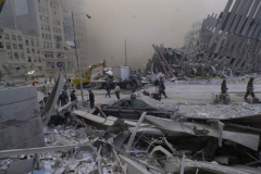 September 12, 2001--World Trade Center--Emergency personnel survey the rubble atop a Port Authority Police Car at first morning's light, September 12, 2001, at Ground Zero of the destroyed World Trade Center (©2001 Kevin P. Coughlin/Independent Photojournalist)