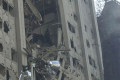September 13, 2001--World Trade Center--The collapse of the South Tower during the September 11 attacks tore a 24-story gash into the facade of the Deutsche Bank Building, seen here on September 13, 2001. (©2001 Kevin P. Coughlin/Independent Photojournalist)