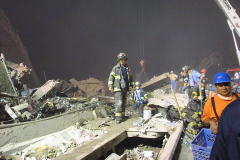 23:19 9-11-2001
Firefighter stands on elements of building 2.

Photographer: Lester J. Millman