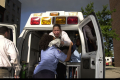 Sept. 11 2001 terrorist attack: Woman injured at the World Trade center is helped off an ambulance at LIC Hospital in Brooklyn, NY. Photo Debbie Egan-Chin
