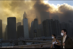 Debbie Egan-Chin photo                               
Manhattan skyline as people walk out of Manhattan across the Brooklyn Bridge on Sept. 11, 2001.