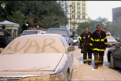 photo Egan-Chin,Debbie
Weary New York Firefighters walk towards the World Trade Center past City Hall where "WAR" has been written in the dust from the collapse of the twin towers on a car windscreen.
New York,NY
