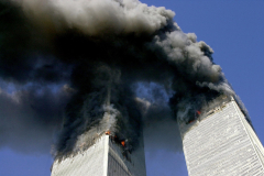 Smoke billows from the upper stories of the World Trade Center after two hijacked passenger planes crash into both towers. Acrid smoke from the 110- story office buildings fill the sky with a plume that can be seen miles away. The buildings burn for about an hour before they both collapse.