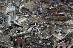 A firefighter stands in the center of what was the West Side Highway, searching for survivors in the rubble of the destroyed World Trade Center. Nearly 3,000 people are believed to have died in the terrorist attacks.