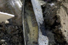 A woman's shoe lays partially buried in the rubble of the fallen World Trade Center. New York City Mayor Rudy Giuliani, initially reluctant to speculate on the death toll, assures, "it will be more than we can bear."