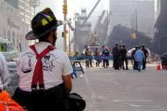 A Fireman catches his breath and grabs a change a clothes outside at Trinity Church located at ground zero in lower Manhattan Sunday 16,2001. Father Peter from the Seamens church on Water St. is in charge of clothes and food for the workers at ground zero in the red zone.(Photo/Suzi Altman)