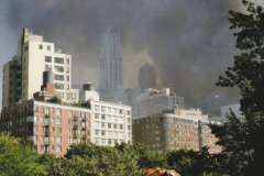 In the afternoon of 9/11, a woman in Tribeca watches smoke rise from the site.