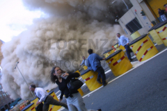 People run from debris caused by the collapse of One World Trade Center, the first tower to fall on September 11, 2001.