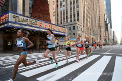 New York City Marathon 21 ÒAbbott Dash to the FinishÓ 11/6/21.  A sea of runners take to the streets of Manhattan for the 5K race.  The race is the warmup event one day before the NYC Marathon.  Runners start at the United Nations and run to the Marathon finish line in Central Park. Here the runners run up 6th Avenue past the Radio City Music Hall.  Copyright Jon Simon