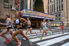 New York City Marathon 21 ÒAbbott Dash to the FinishÓ 11/6/21.  A sea of runners take to the streets of Manhattan for the 5K race.  The race is the warmup event one day before the NYC Marathon.  Runners start at the United Nations and run to the Marathon finish line in Central Park. Here the runners run up 6th Avenue past the Radio City Music Hall.  Copyright Jon Simon