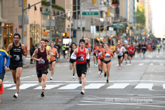 New York City Marathon 21 ÒAbbott Dash to the FinishÓ 11/6/21.  A sea of runners take to the streets of Manhattan for the 5K race.  The race is the warmup event one day before the NYC Marathon.  Runners start at the United Nations and run to the Marathon finish line in Central Park. Here the runners run up 6th Avenue past the Radio City Music Hall.  Copyright Jon Simon