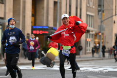 New York City Marathon 21 ÒAbbott Dash to the FinishÓ 11/6/21.  A sea of runners take to the streets of Manhattan for the 5K race.  The race is the warmup event one day before the NYC Marathon.  Runners start at the United Nations and run to the Marathon finish line in Central Park. Here the runners run up 6th Avenue past the Radio City Music Hall.  Copyright Jon Simon
