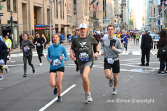 New York City Marathon 21 ÒAbbott Dash to the FinishÓ 11/6/21.  A sea of runners take to the streets of Manhattan for the 5K race.  The race is the warmup event one day before the NYC Marathon.  Runners start at the United Nations and run to the Marathon finish line in Central Park. Here the runners run up 6th Avenue past the Radio City Music Hall.  Copyright Jon Simon