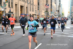 New York City Marathon 21 ÒAbbott Dash to the FinishÓ 11/6/21.  A sea of runners take to the streets of Manhattan for the 5K race.  The race is the warmup event one day before the NYC Marathon.  Runners start at the United Nations and run to the Marathon finish line in Central Park. Here the runners run up 6th Avenue past the Radio City Music Hall.  Copyright Jon Simon