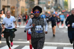 New York City Marathon 21 ÒAbbott Dash to the FinishÓ 11/6/21.  A sea of runners take to the streets of Manhattan for the 5K race.  The race is the warmup event one day before the NYC Marathon.  Runners start at the United Nations and run to the Marathon finish line in Central Park. Here the runners run up 6th Avenue past the Radio City Music Hall.  Copyright Jon Simon