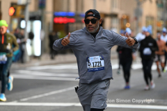 New York City Marathon 21 ÒAbbott Dash to the FinishÓ 11/6/21.  A sea of runners take to the streets of Manhattan for the 5K race.  The race is the warmup event one day before the NYC Marathon.  Runners start at the United Nations and run to the Marathon finish line in Central Park. Here the runners run up 6th Avenue past the Radio City Music Hall.  Copyright Jon Simon