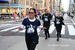 New York City Marathon 21 ÒAbbott Dash to the FinishÓ 11/6/21.  A sea of runners take to the streets of Manhattan for the 5K race.  The race is the warmup event one day before the NYC Marathon.  Runners start at the United Nations and run to the Marathon finish line in Central Park. Here the runners run up 6th Avenue past the Radio City Music Hall.  Copyright Jon Simon