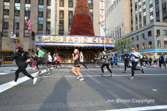 New York City Marathon 21 ÒAbbott Dash to the FinishÓ 11/6/21.  A sea of runners take to the streets of Manhattan for the 5K race.  The race is the warmup event one day before the NYC Marathon.  Runners start at the United Nations and run to the Marathon finish line in Central Park. Here the runners run up 6th Avenue past the Radio City Music Hall.  Copyright Jon Simon