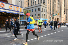 New York City Marathon 21 ÒAbbott Dash to the FinishÓ 11/6/21.  A sea of runners take to the streets of Manhattan for the 5K race.  The race is the warmup event one day before the NYC Marathon.  Runners start at the United Nations and run to the Marathon finish line in Central Park. Here the runners run up 6th Avenue past the Radio City Music Hall.  Copyright Jon Simon