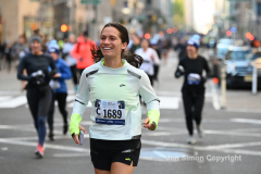 New York City Marathon 21 ÒAbbott Dash to the FinishÓ 11/6/21.  A sea of runners take to the streets of Manhattan for the 5K race.  The race is the warmup event one day before the NYC Marathon.  Runners start at the United Nations and run to the Marathon finish line in Central Park. Here the runners run up 6th Avenue past the Radio City Music Hall.  Copyright Jon Simon