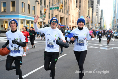 New York City Marathon 21 ÒAbbott Dash to the FinishÓ 11/6/21.  A sea of runners take to the streets of Manhattan for the 5K race.  The race is the warmup event one day before the NYC Marathon.  Runners start at the United Nations and run to the Marathon finish line in Central Park. Here the runners run up 6th Avenue past the Radio City Music Hall.  Copyright Jon Simon