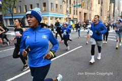 New York City Marathon 21 ÒAbbott Dash to the FinishÓ 11/6/21.  A sea of runners take to the streets of Manhattan for the 5K race.  The race is the warmup event one day before the NYC Marathon.  Runners start at the United Nations and run to the Marathon finish line in Central Park. Here the runners run up 6th Avenue past the Radio City Music Hall.  Copyright Jon Simon