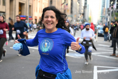 New York City Marathon 21 ÒAbbott Dash to the FinishÓ 11/6/21.  A sea of runners take to the streets of Manhattan for the 5K race.  The race is the warmup event one day before the NYC Marathon.  Runners start at the United Nations and run to the Marathon finish line in Central Park. Here the runners run up 6th Avenue past the Radio City Music Hall.  Copyright Jon Simon