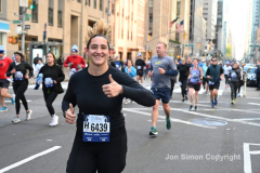 New York City Marathon 21 ÒAbbott Dash to the FinishÓ 11/6/21.  A sea of runners take to the streets of Manhattan for the 5K race.  The race is the warmup event one day before the NYC Marathon.  Runners start at the United Nations and run to the Marathon finish line in Central Park. Here the runners run up 6th Avenue past the Radio City Music Hall.  Copyright Jon Simon